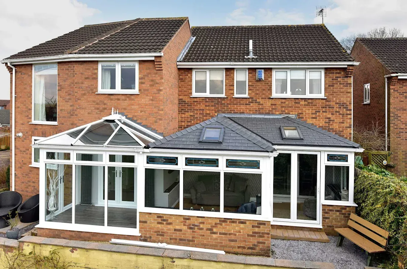 Example of a conservatory roof conversion by Conservatory Roofs 4 You, showing a tiled warm roof next to a glass-roofed conservatory.