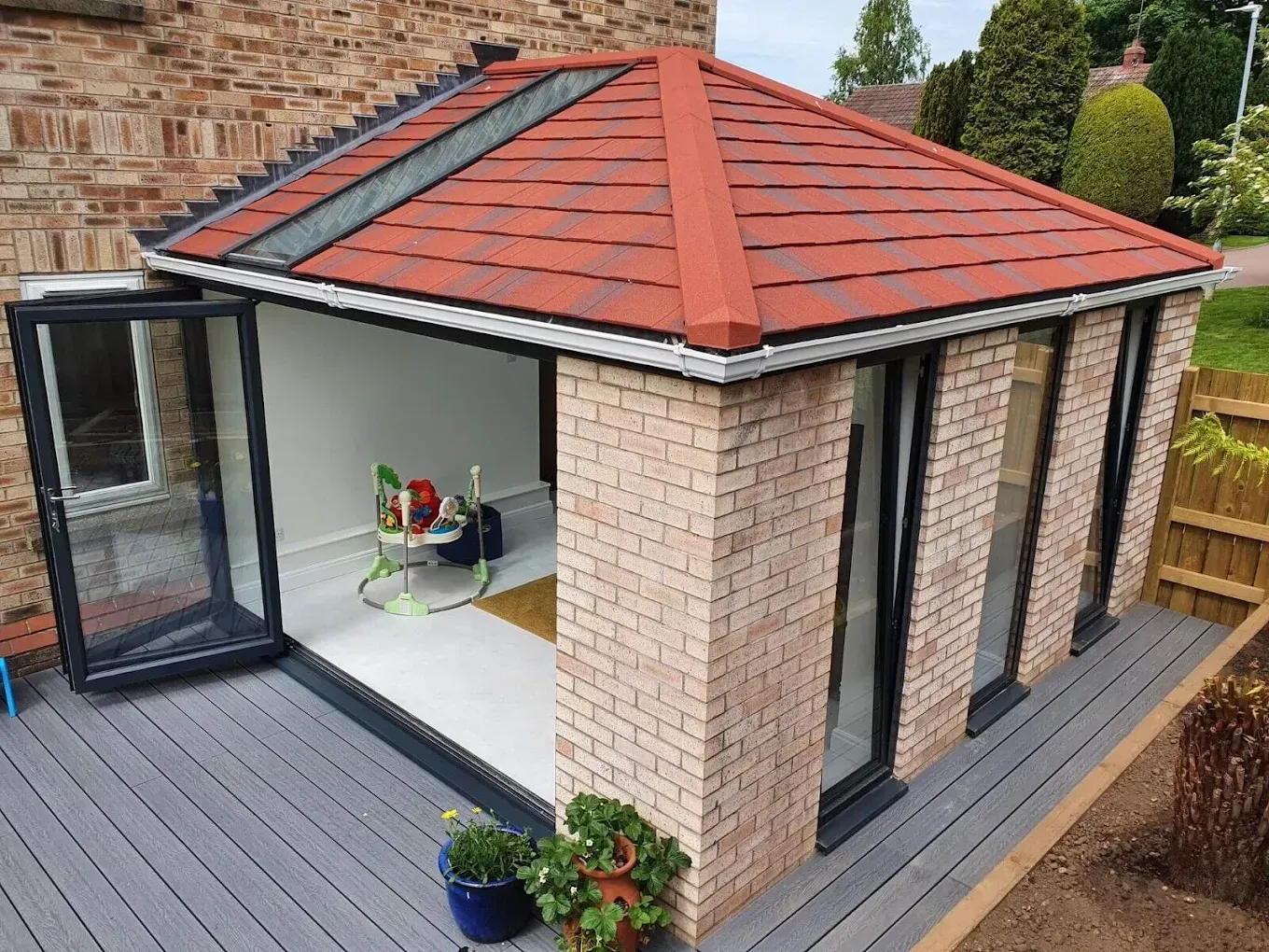 Transformed conservatory with tiled roof and bi-fold doors